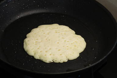 Bubbles on the top side of a flapjack in the pan