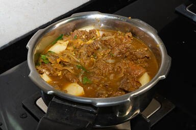 Fleisch und Kartoffel mit Wasser im Druckkochtopf - Beef and potato with water in the pressure cooker