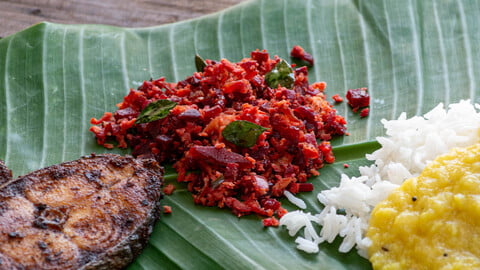 Beetroot Thoran on a banana leaf with fish, yellow dal and rice